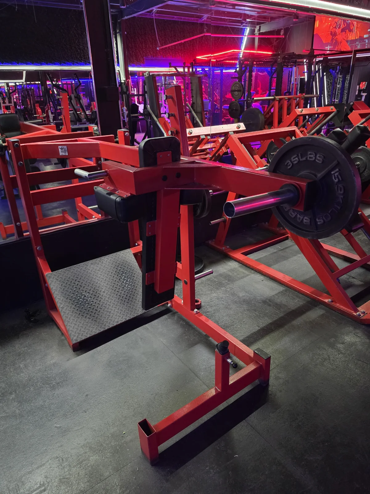 Plate-loaded pendulum squat machine at Iron Arms Gym