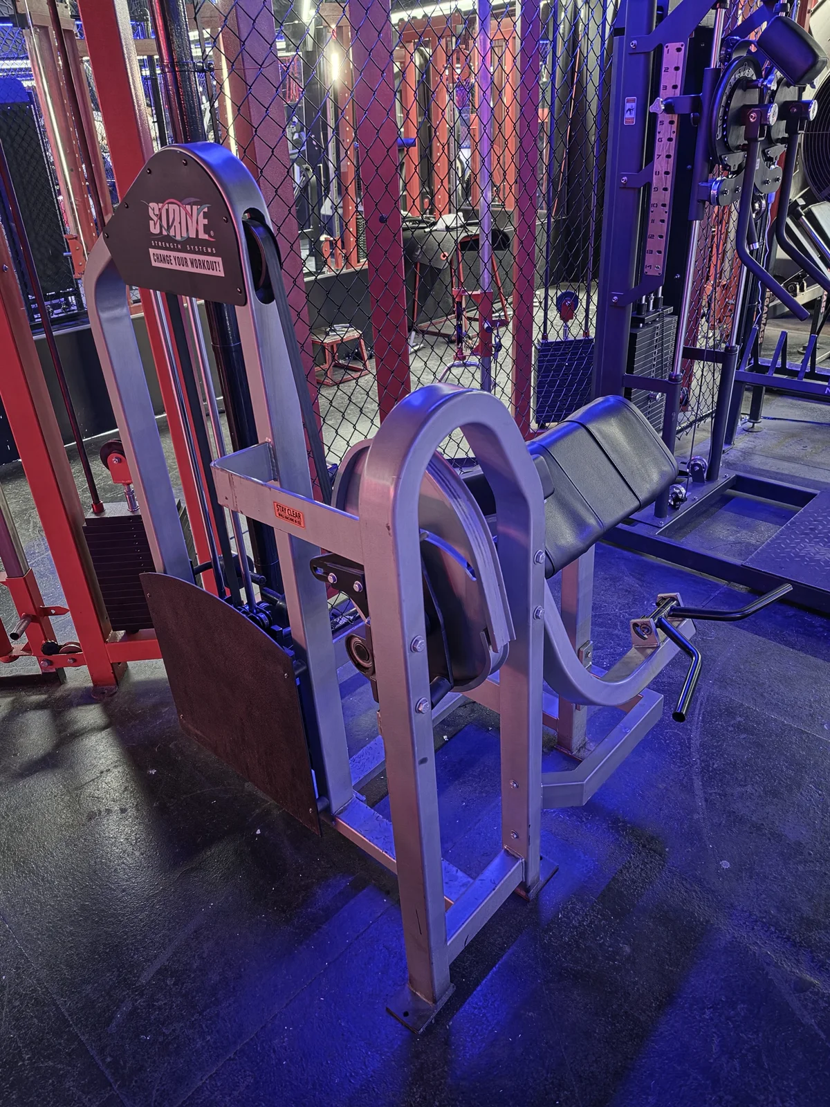 Strive preacher curl machine with adjustable strength curve at Iron Arms Gym